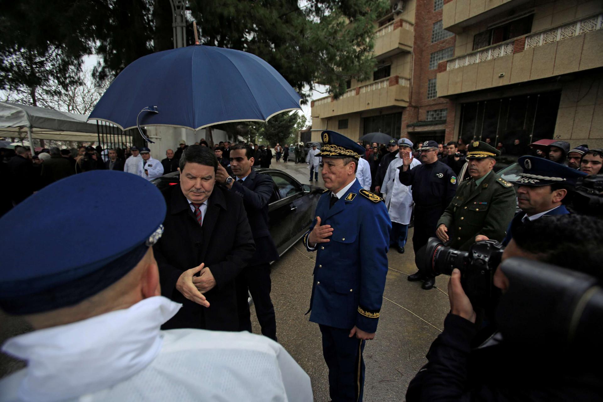 Abdelghani Hamel, former Director General of the Algerian National Police (DGSN) greets a police officer in Algiers, Algeria, March 7, 2016