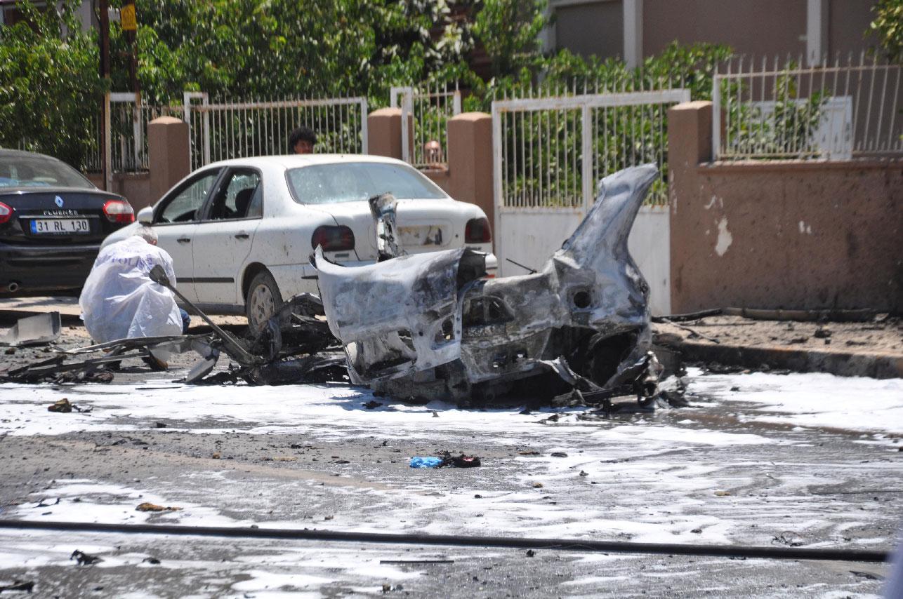 A forensic officer inspects the blast site in Reyhanli, a Turkish town in Hatay province near the border with Syria