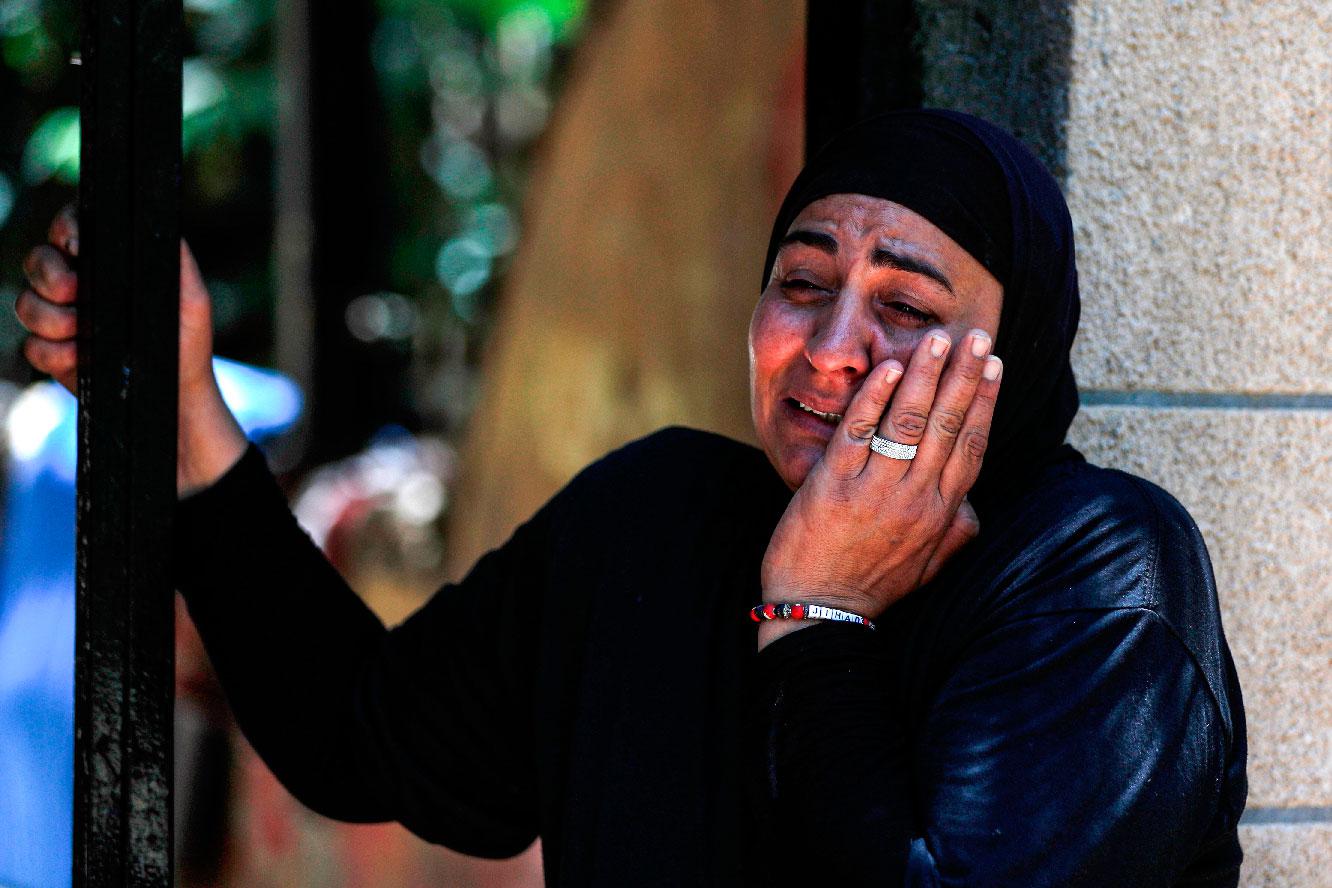 A Palestinian woman of the Siyam family reacts as the family is evicted from their home in the Palestinian neighbourhood of Silwan