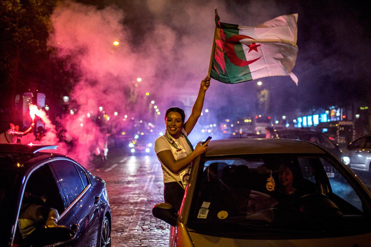 Algeria supporters celebrate on the Champs-Elysees in Paris