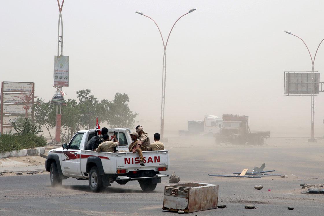 Members of UAE-backed southern Yemeni forces patrol a road during clashes with government forces in Aden, Yemen