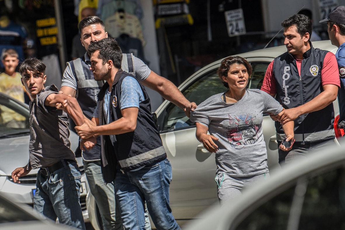 Turkish police officer detain demonstrators during a protest against the replacement of Kurdish mayors in Diyarbakir