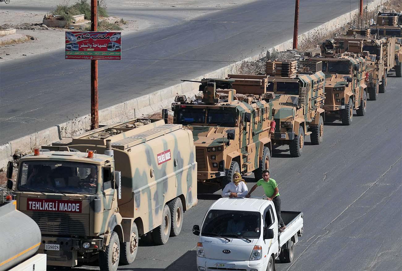 A convoy of Turkish military vehicles passes through Maaret al-Numan in Syria's northern province of Idlib reportedly heading toward the town of Khan Sheikhun