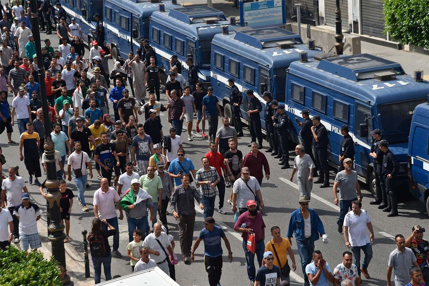 Algerian protesters take part in a demonstration against the ruling class in Algeria's capital Algiers