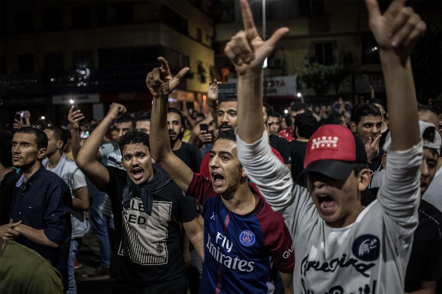 Protesters shout slogans during a rare anti-government protest in Downtown Cairo