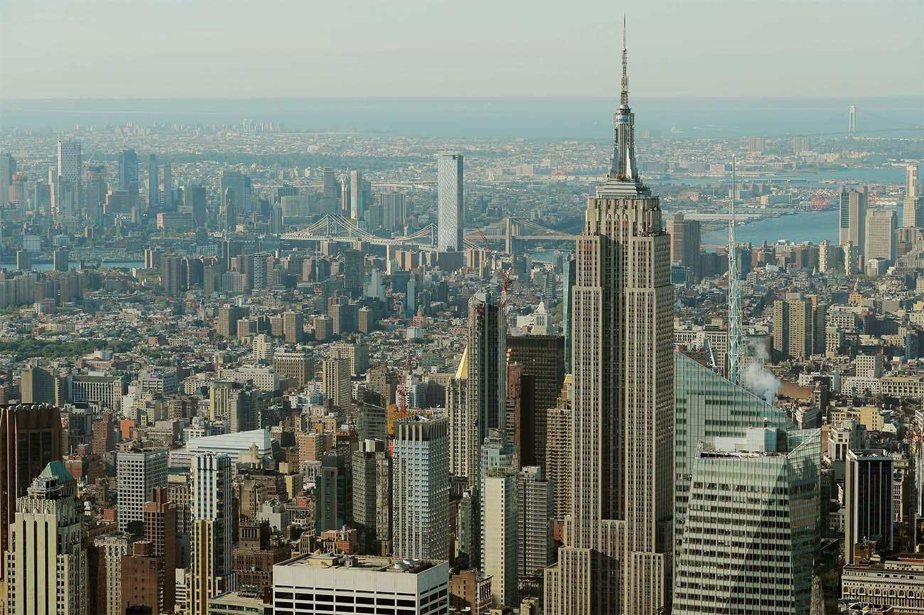 The Empire State Building rises above Manhattan in front of the Brooklyn and Manhattan bridges