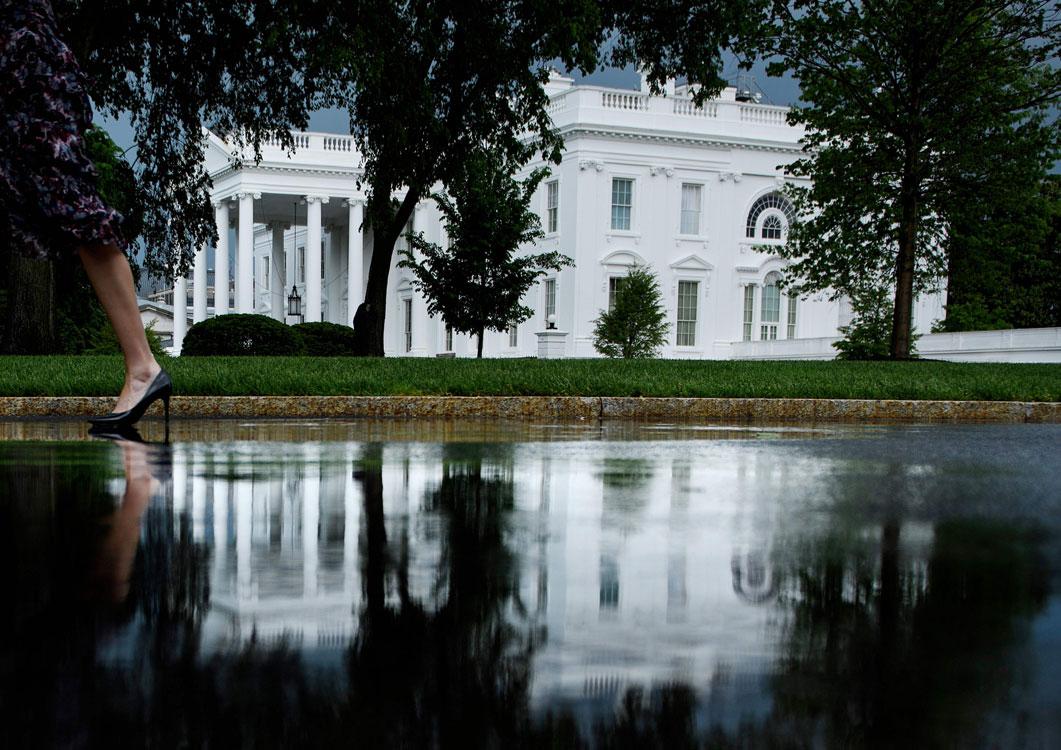 A person walks past the White House in Washington, DC