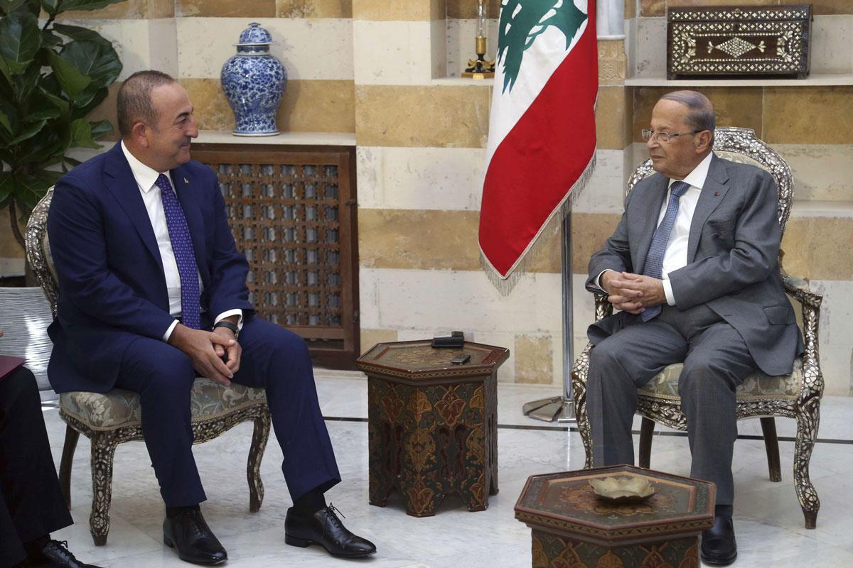Lebanese President Michel Aoun, right, meets with Turkish Foreign Minister Mevlut Cavusoglu in Beirut