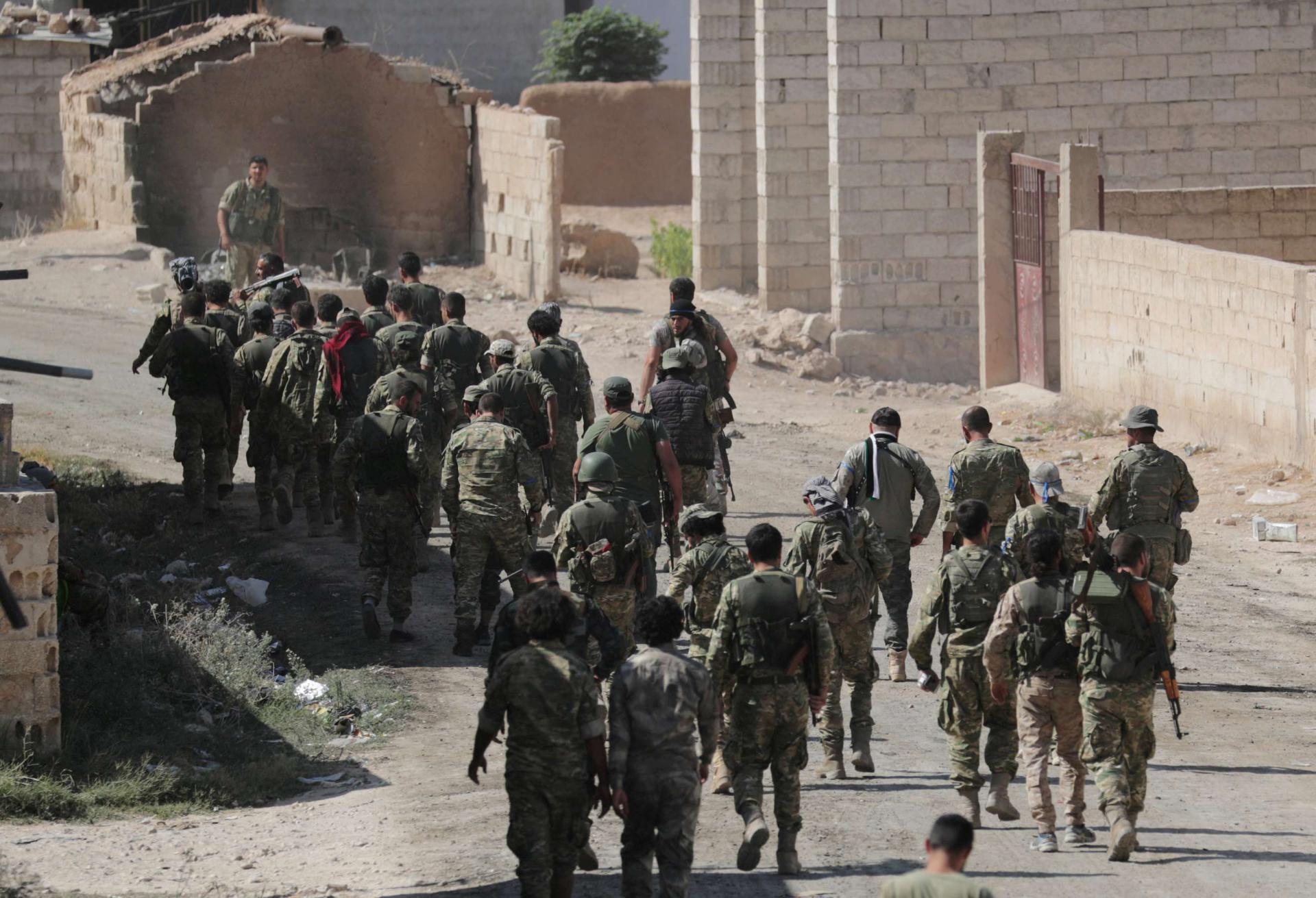 Gunfire resounded early on Sunday around Ras al Ain, one of two Syrian towns which are the focus of the attack