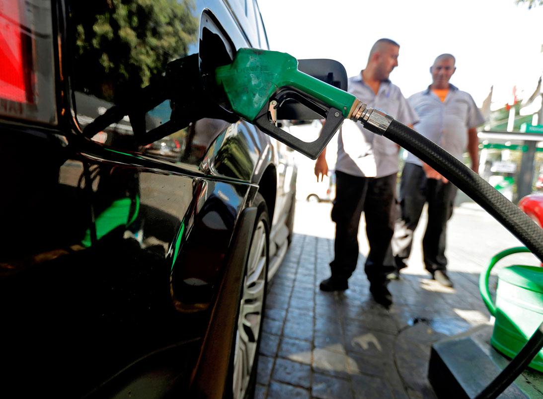 A driver fills his tank at a petrol station in the Lebanese capital Beirut