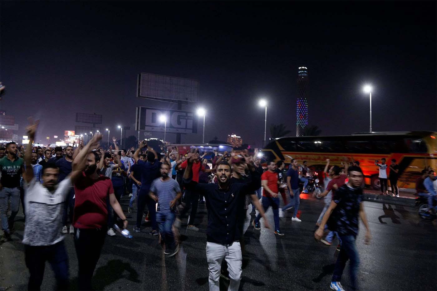 Egyptian protesters shout slogans as they take part in a protest calling for the removal of President Abdel Fattah al-Sisi in Cairo's downtown on September 20