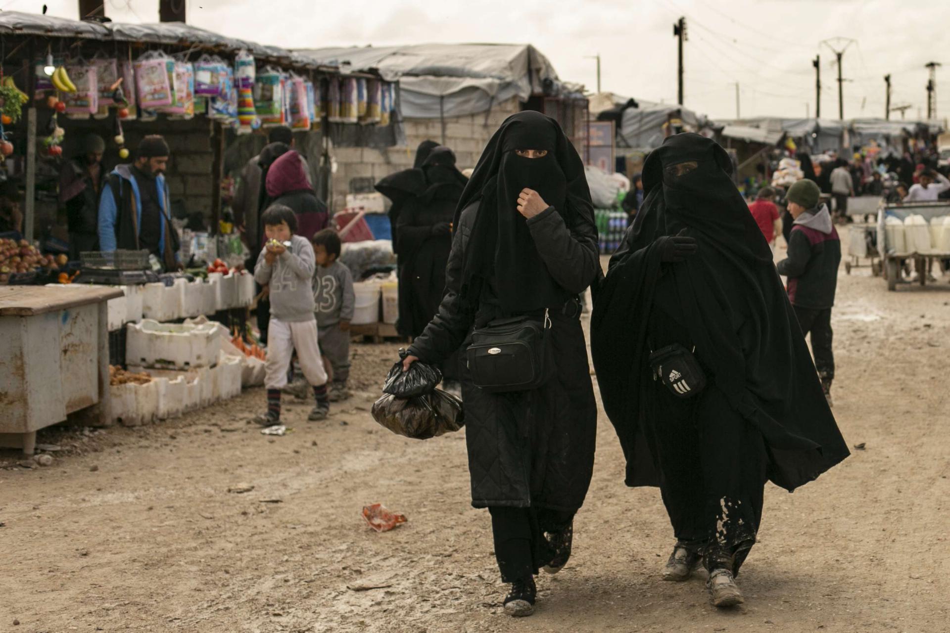 Women shop in the marketplace at al-Hol camp, home to families of Islamic State fighters, in Hasakeh province, Syria