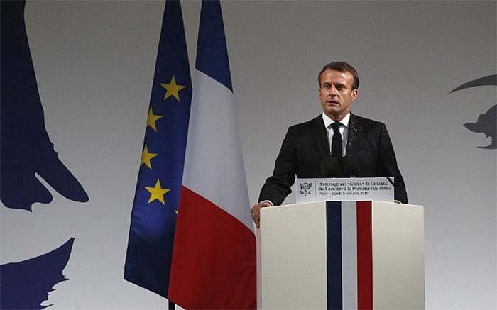 Macron addressing a ceremony at the Paris police headquarters where the attack took place