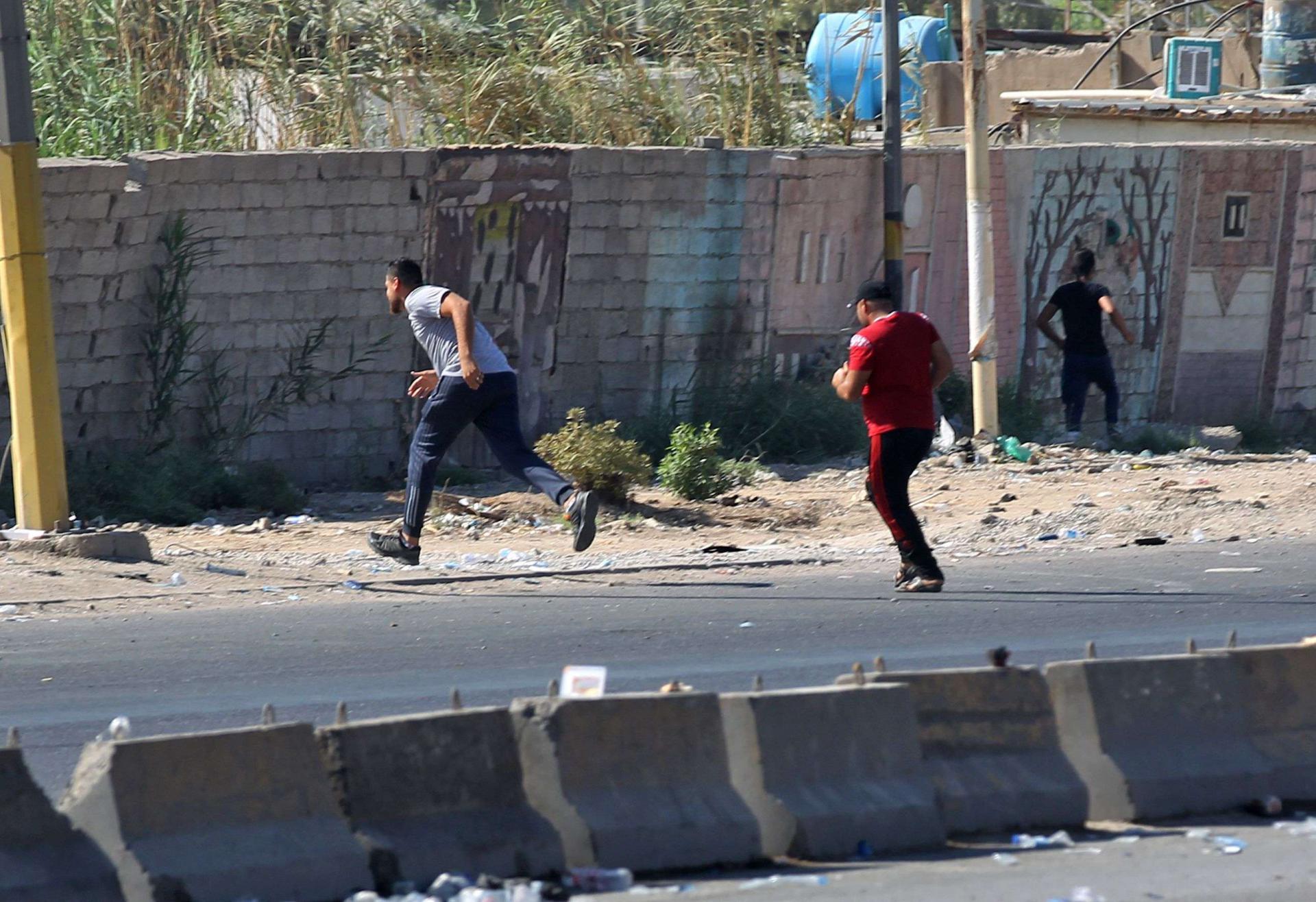 Iraqi protesters run during demonstration against state corruption and failing public services