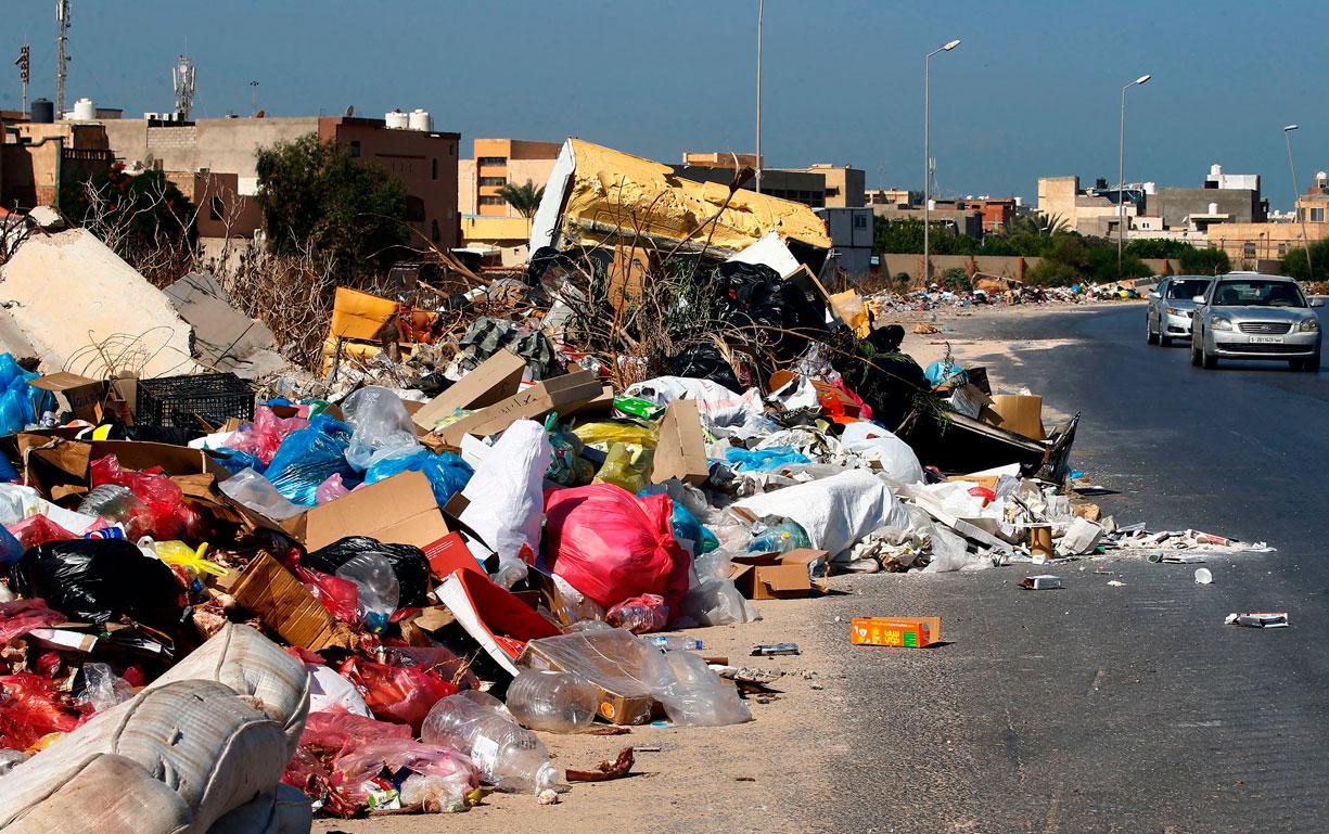 A view of rubbish piling up along the side of a street in the Libyan capital Tripoli