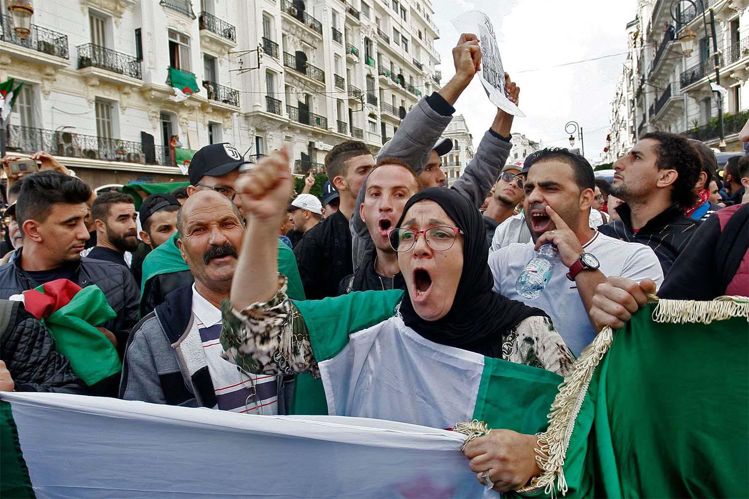 Algerian protesters chant slogans during the 37th consecutive Friday anti-government protests in Algiers