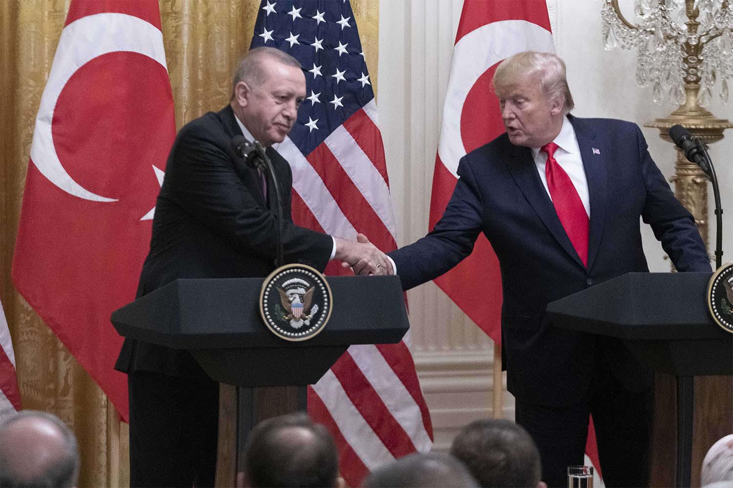 US President Donald Trump (R) shakes hands with Turkish President Recep Tayyip Erdogan during their joint press conference