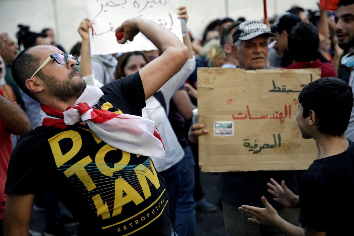 A protester throws a tomato at Lebanon's central bank during a demonstration in Beirut