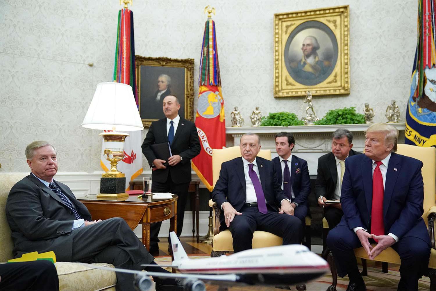 Sen. Lindsey Graham (L) listens as US President Donald Trump and Turkey's President Recep Tayyip Erdogan(C) 