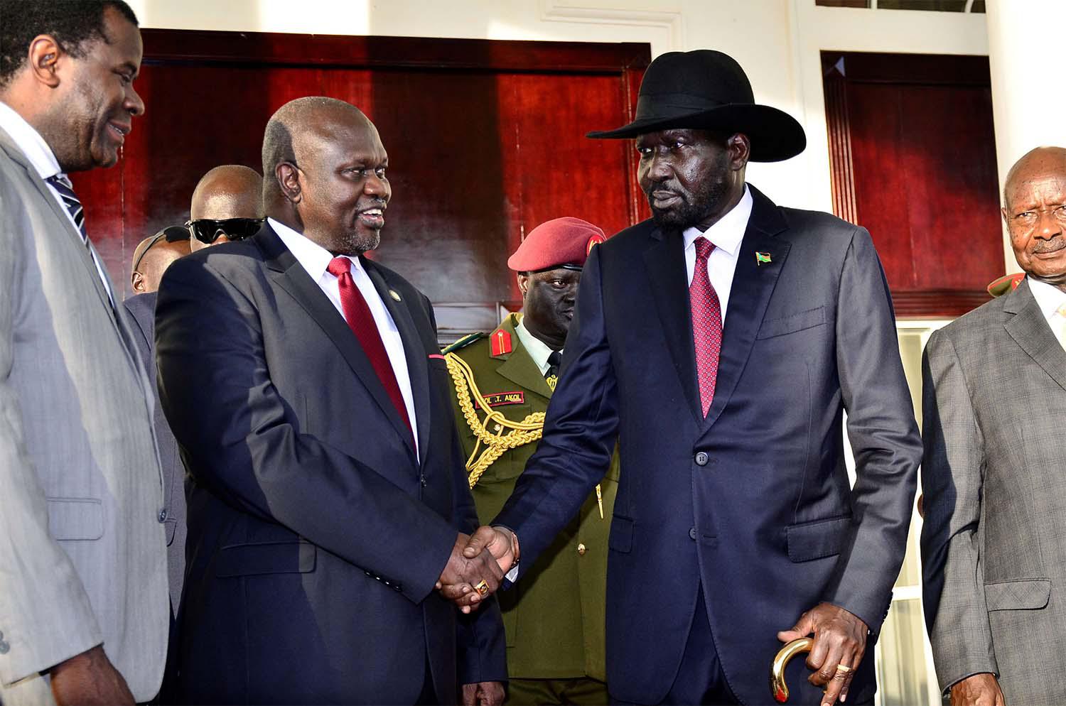 Leader of the Sudan People's Liberation Movement In Opposition (SPLM-IO) Riek Machar shakes hands with South Sudan's President Salva Kiir 