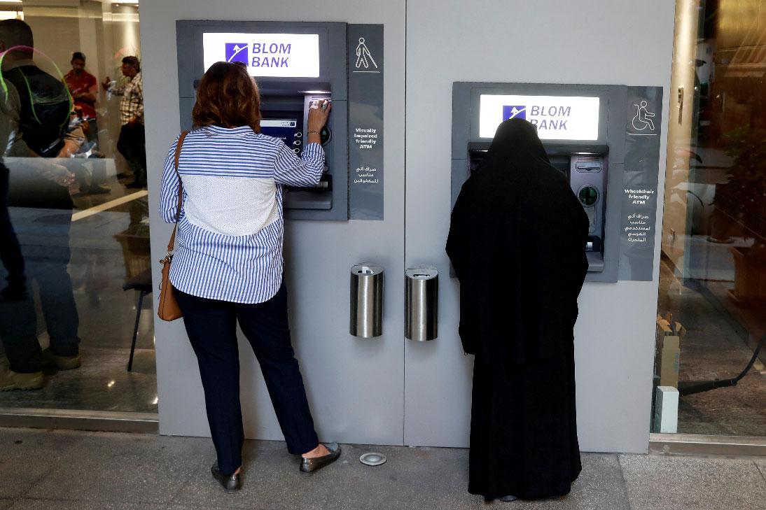 Women use ATMs at Blom bank in Beirut