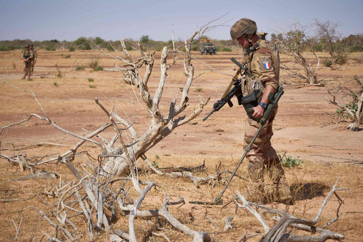 A French soldier holds a detector while searching for the presence of IEDs in northern Burkina Faso
