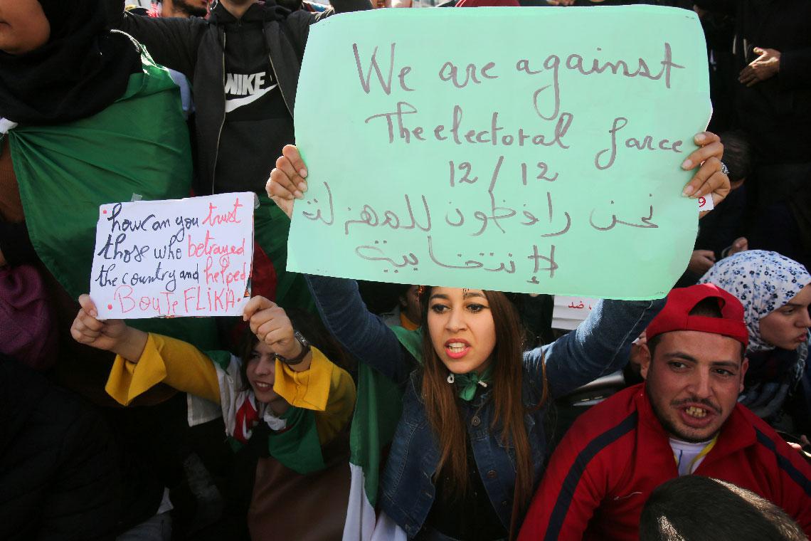 Demonstrators shout slogans during a protest calling to reject the presidential election in Algiers