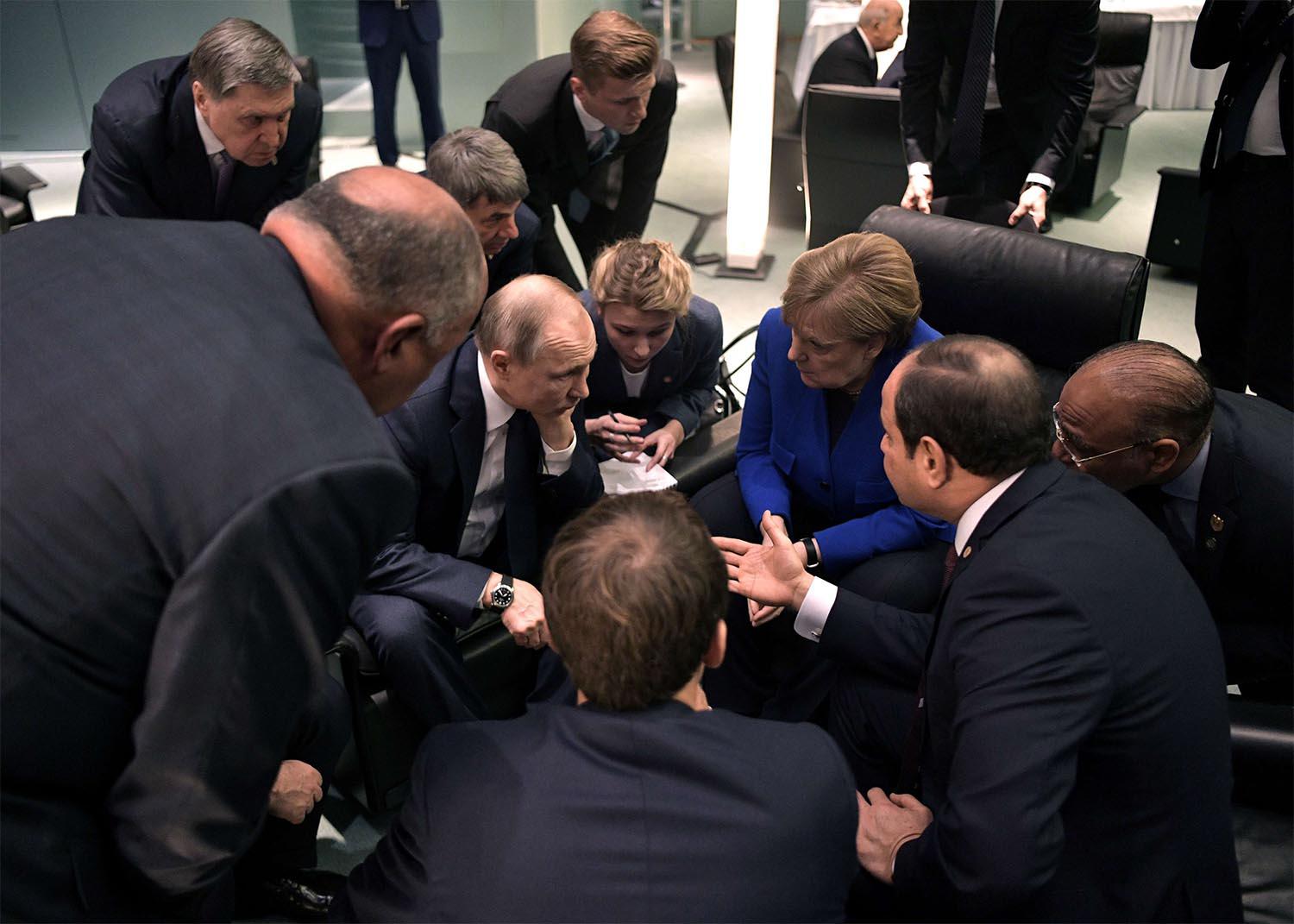 Russia's President Vladimir Putin and German Chancellor Angela Merkel meet on sideline of the Libya summit in Berlin