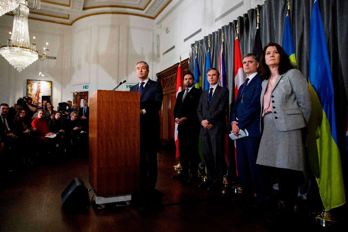 Canadian Minister of Foreign Affairs Francois-Philippe Champagne (C) addresses a press conference