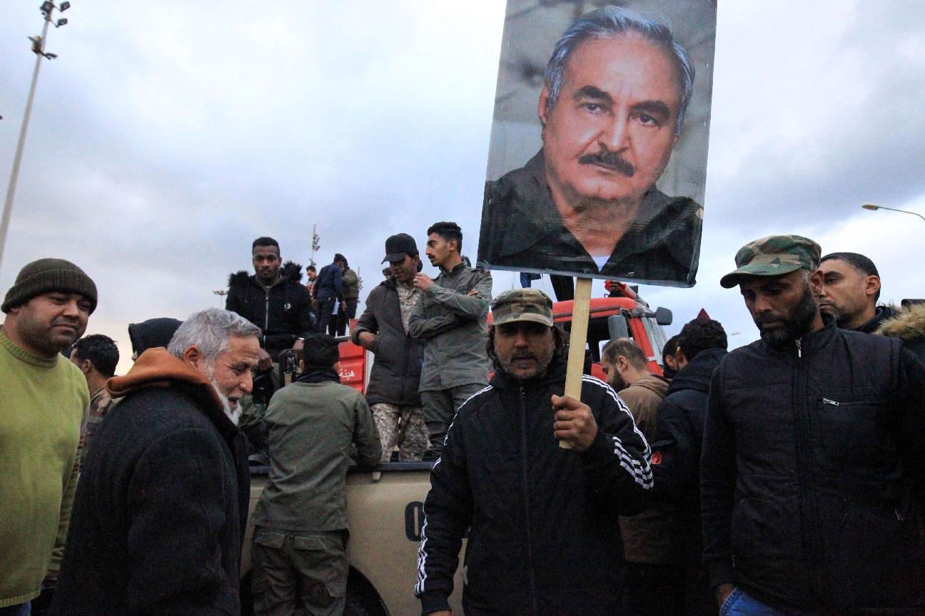 People raise a picture of Libyan strongman Khalifa Haftar as they take part in a demonstration held in the eastern Libyan city of Benghazi