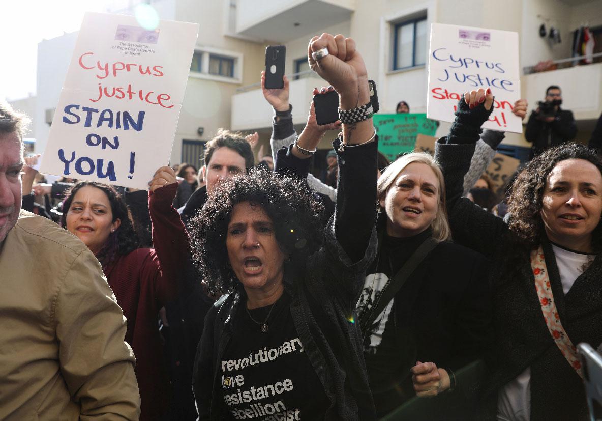 Activists take part in a demonstration outside the courthouse in Paralimni