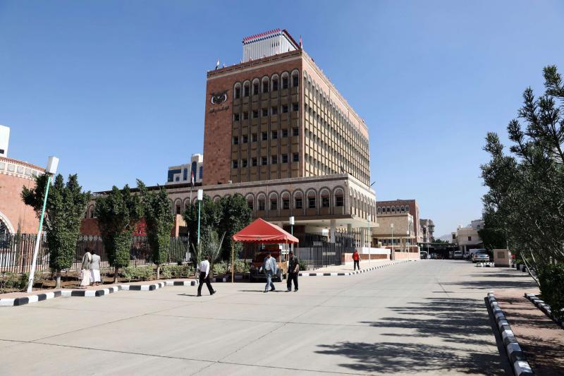 People walk at the yard of the Central Bank of Yemen in Sanaa