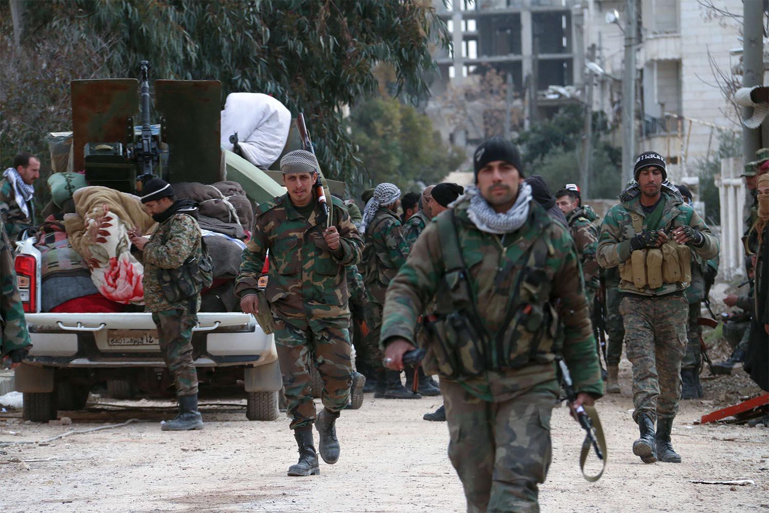 Members of the Syrian army deploy in the al-Rashidin 1 district, in Aleppo's southwestern countryside