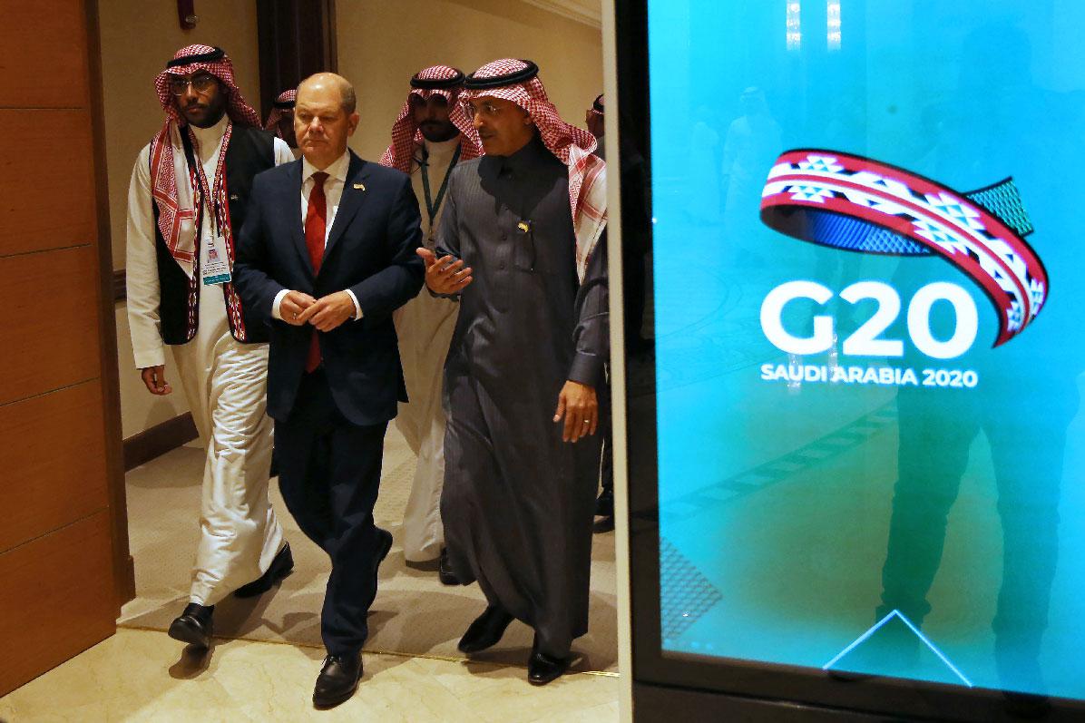 German Finance Minister Olaf Scholz and Saudi Minister of Finance Mohammed al-Jadaan walk to the G20 finance ministers and central bank governors meeting hall in Riyadh