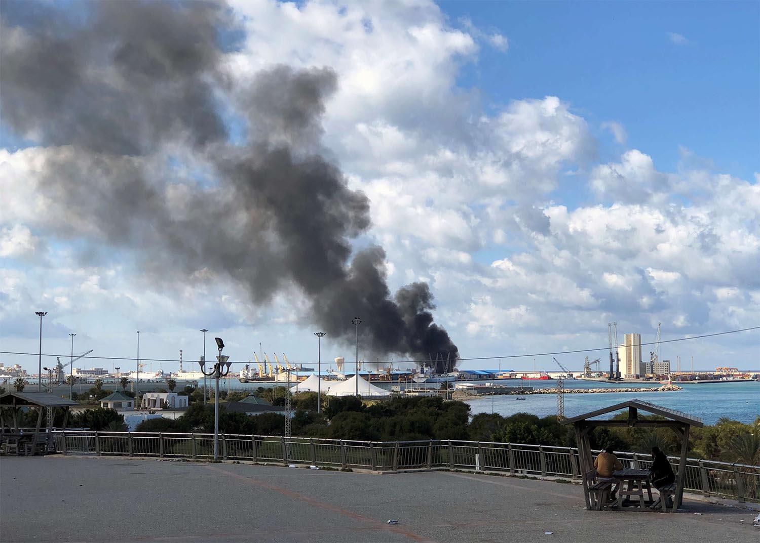 A smoke rises from a port of Tripoli after being attacked