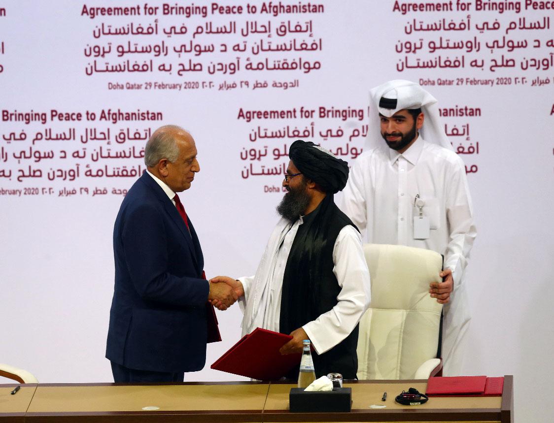 Zalmay Khalilzad, US envoy for peace in Afghanistan and Mullah Abdul Ghani Baradar, the leader of the Taliban delegation