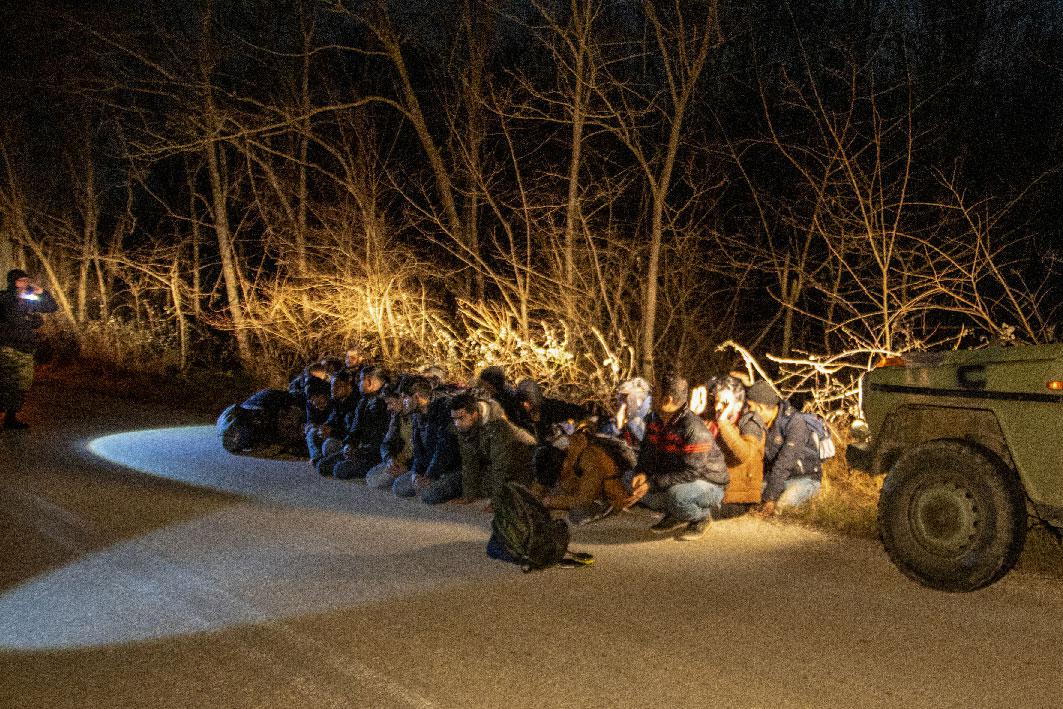 Greek Army soldiers detain a group of migrants that crossed from Turkey to Greece, near the village of Protoklisi, in the region of Evros, Greece