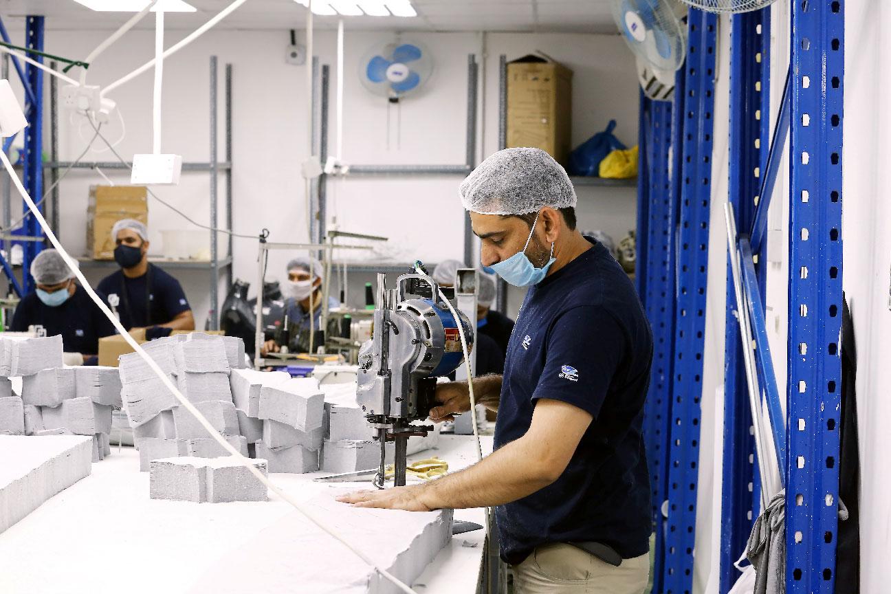 A worker sews pieces of cloth to make face masks at a factory, following the outbreak of coronavirus disease (COVID-19), in Ajman, United Arab Emirates