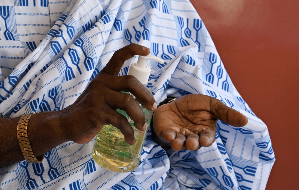 A man disinfects his hands in Abidjan, Ivory Coast
