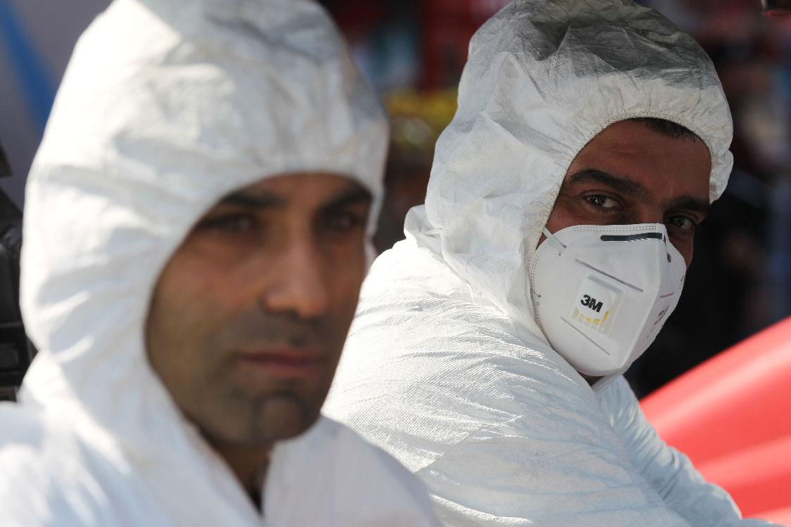 An Iraqi Civil Defence teams disinfects the streets of Sadr City in Baghdad