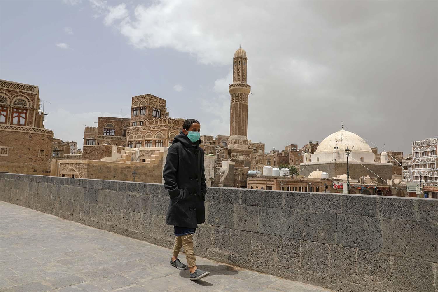 A girl wears a protective face mask amid fears of the spread of the coronavirus disease (COVID-19) in Sanaa