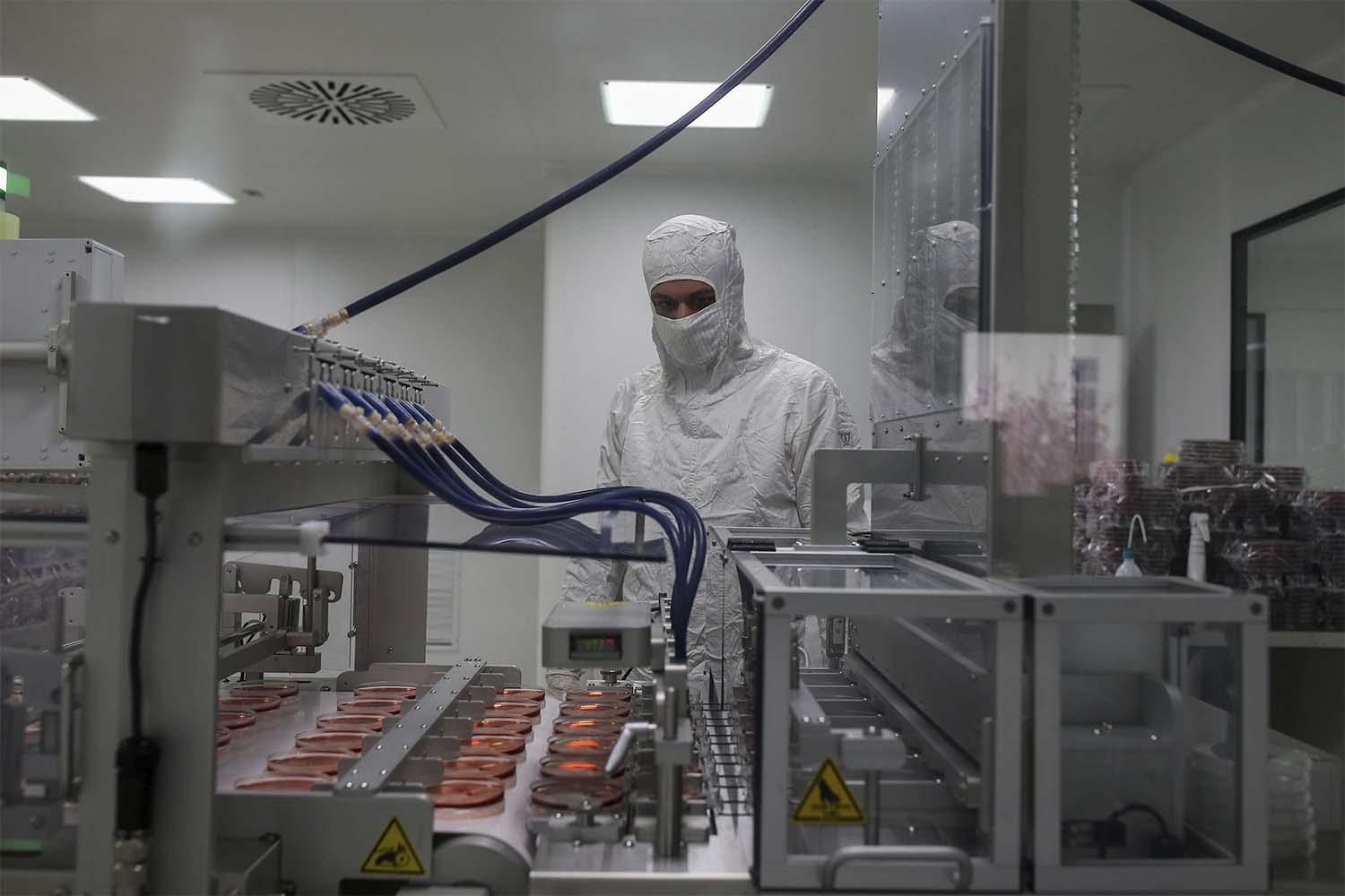 A worker oversees the production of coronavirus testing kits in Gebze, northwestern Turkey,