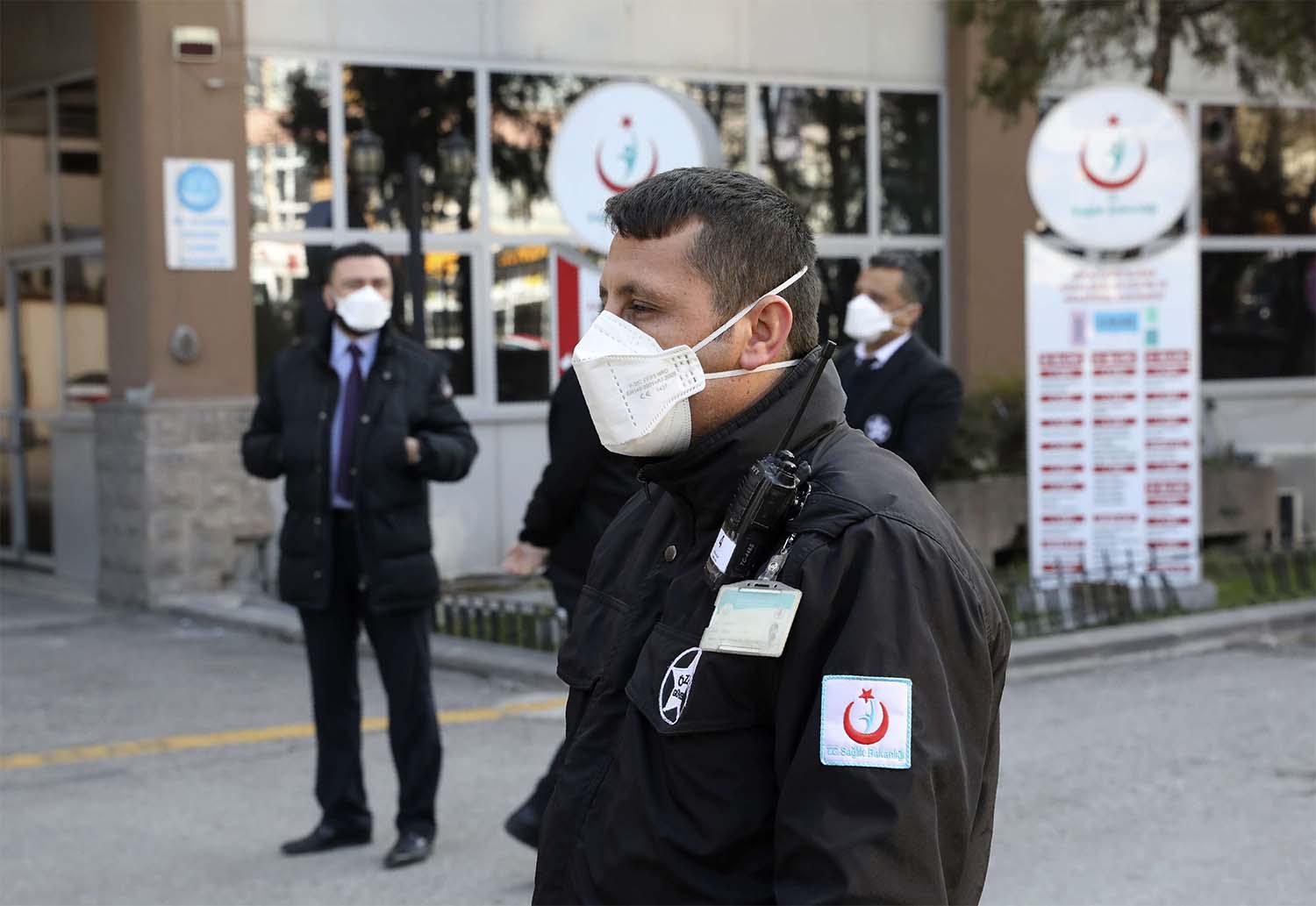 Security officials stand at the entrance of Zekai Tahir Burak Hospital where 17 passengers of a Turkish Airlines flight from Tehran
