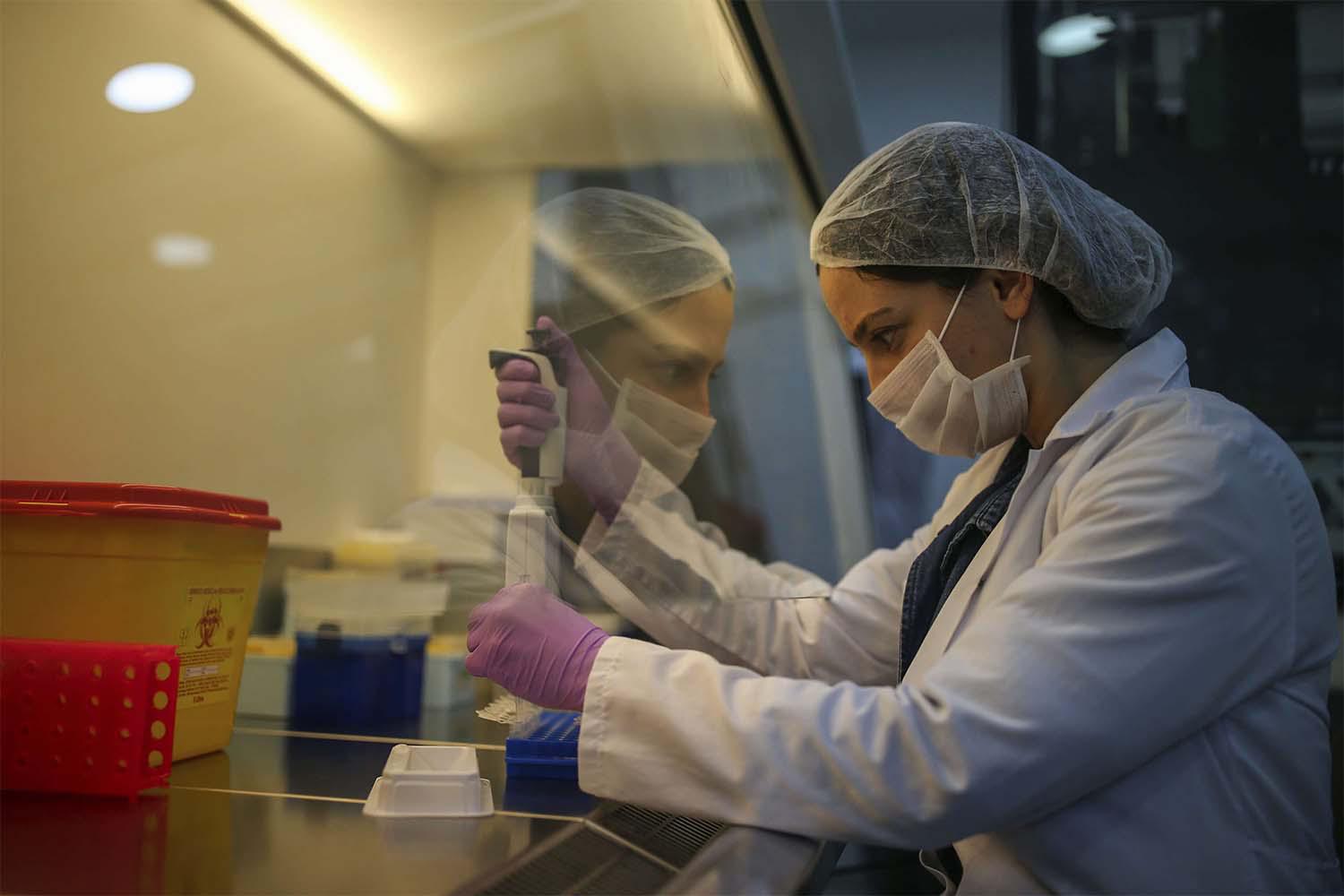 Research and development company employee works on the production of coronavirus testing kits in Gebze