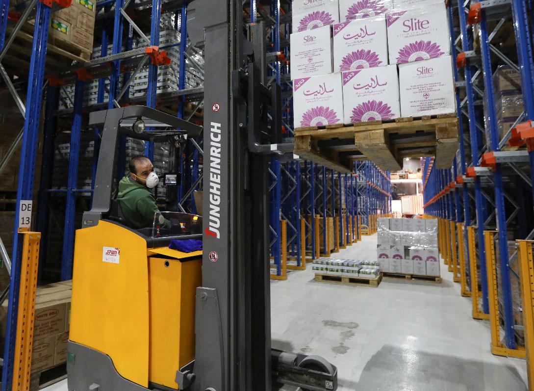 A worker wears a protective face mask as he works at Bohsali food warehouse
