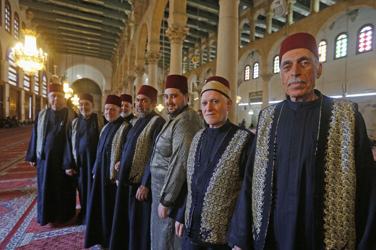 Muezzins, who call Muslims to prayer, pose for a picture at the Umayyad Mosque in the ancient quarters of Damascus