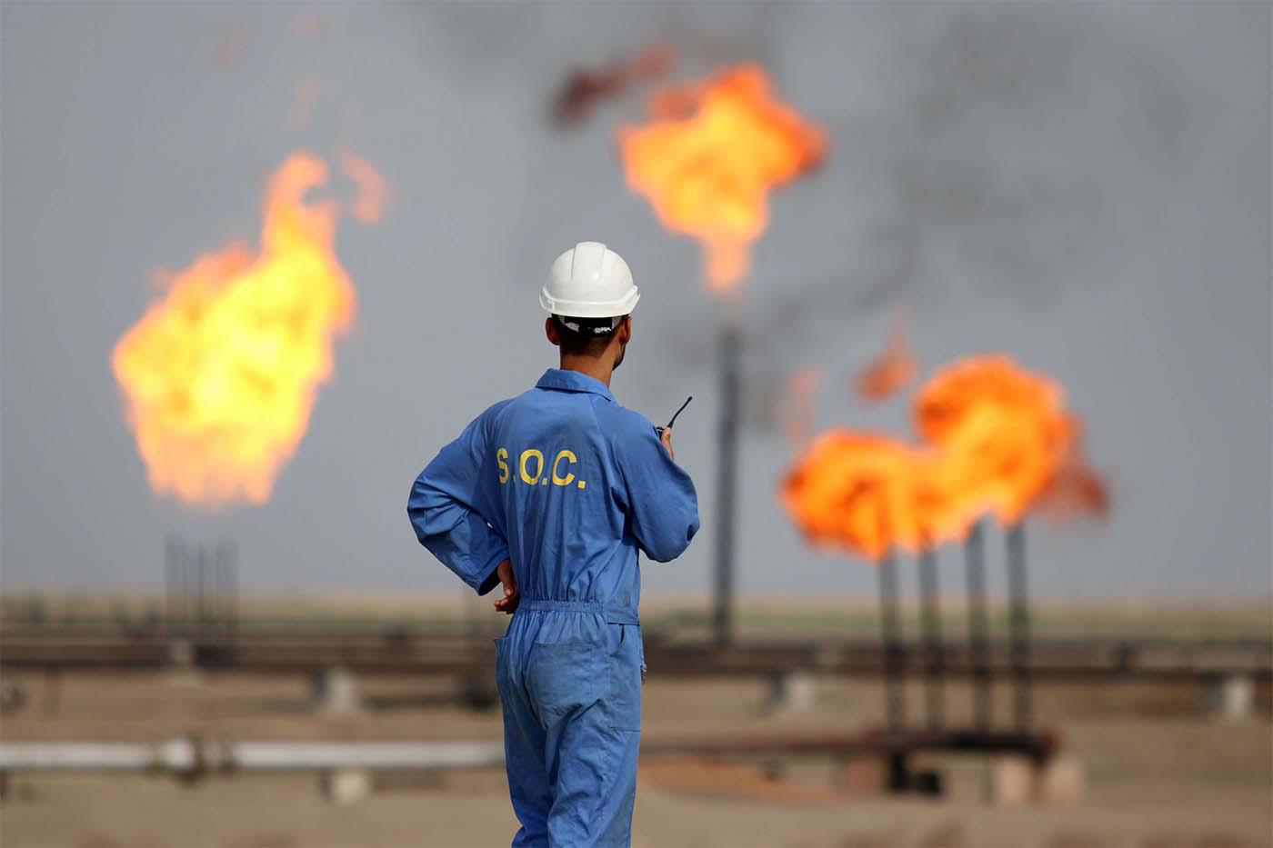 Iraqi oil worker speaks on a radio transciever at an oil refinery in the southern town Nasiriyah
