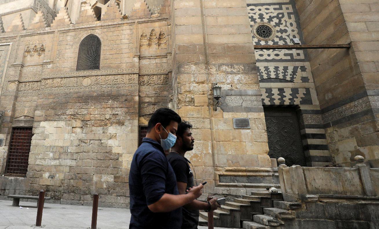 Men are seen walking as mosques are closed in old Islamic Cairo, Egypt