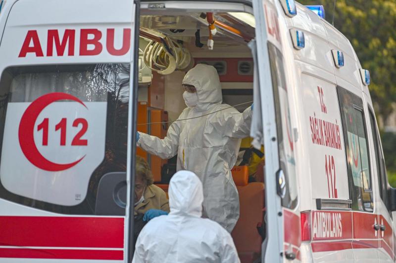 First aid workers look after a woman suspected of being infected with COVID-19