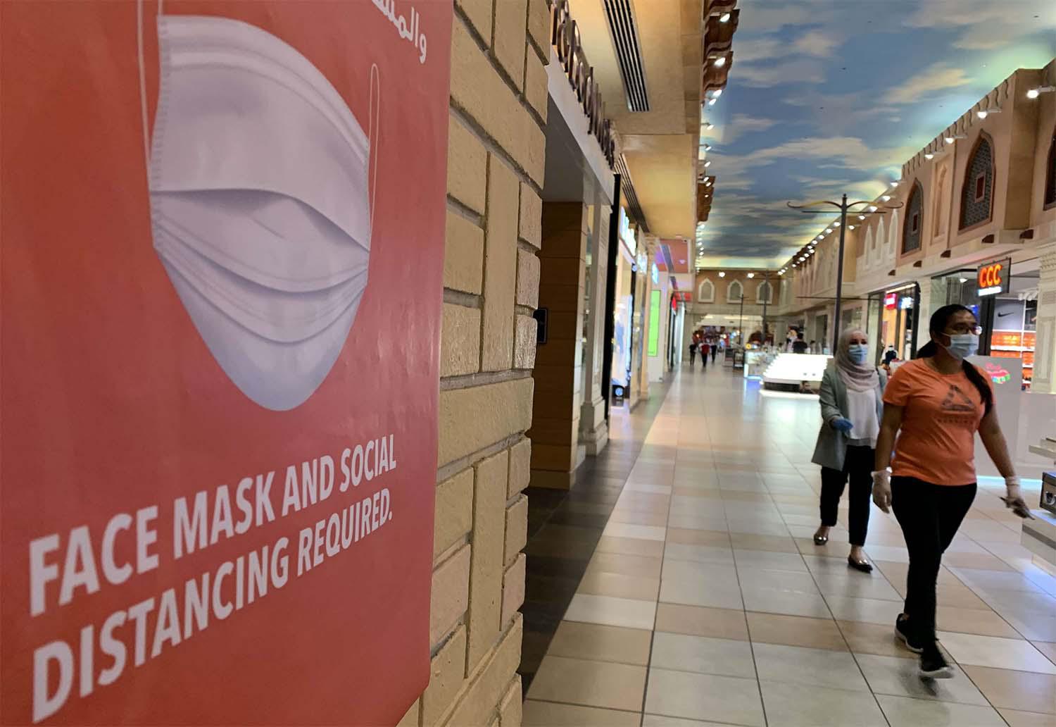 People, wearing protective masks to prevent the spread of the coronavirus, walk in Ibn Battuta mall in Dubai